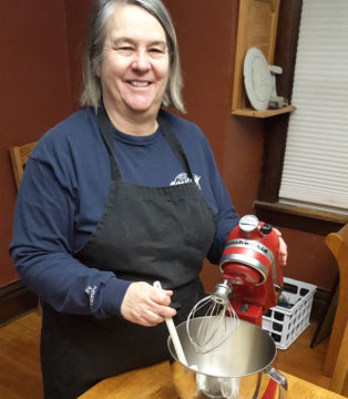 Cathy Sis, Westby Creamery accountant, mixing with a KitchenAid for her New York Cheesecake