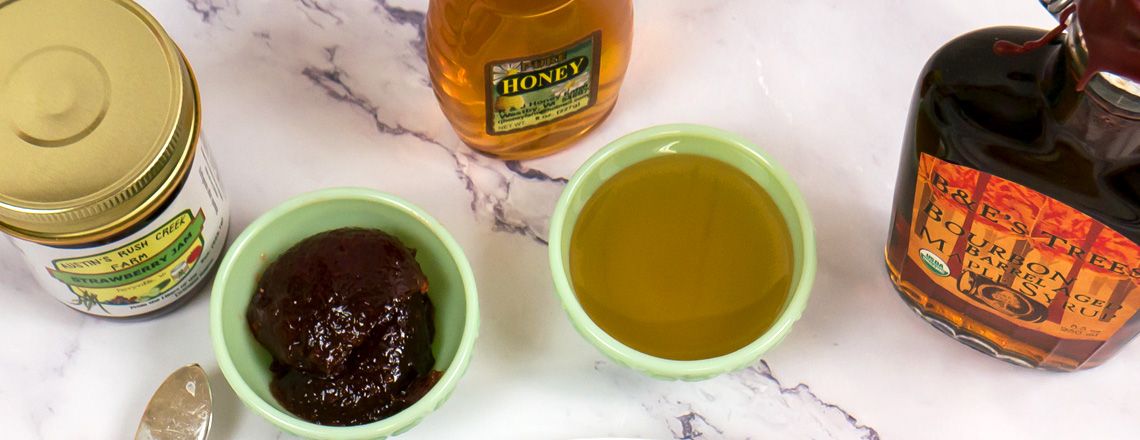 Sample of Westby Cooperative Creamery strawberry jam, honey, and bourbon barrel aged maple syrup.