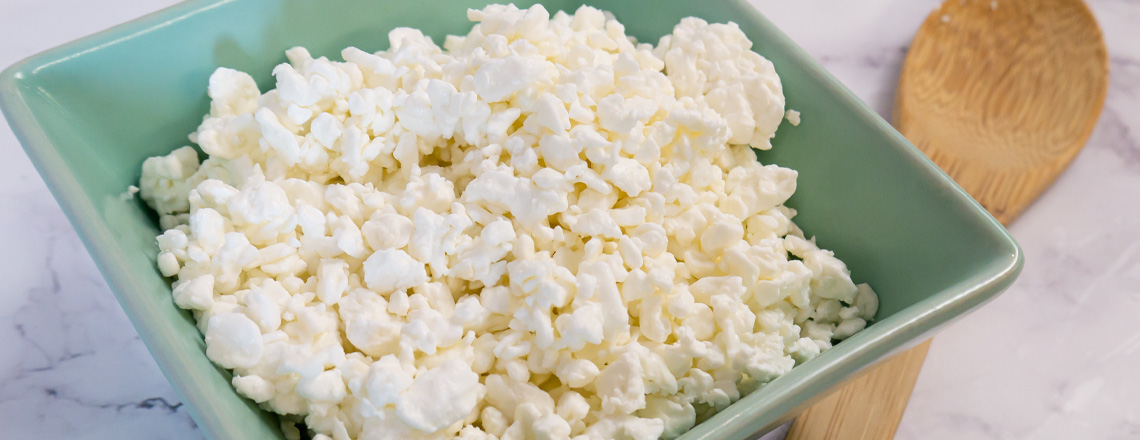 Close up of Westby Cooperative Creamery dry curd cottage cheese in a light blue bowl.