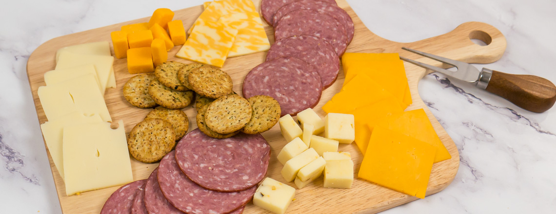 Charcuterie board of Wisconsin meats and cheeses available for purchase online and at the Westby Cooperative Creamery Retail Store.