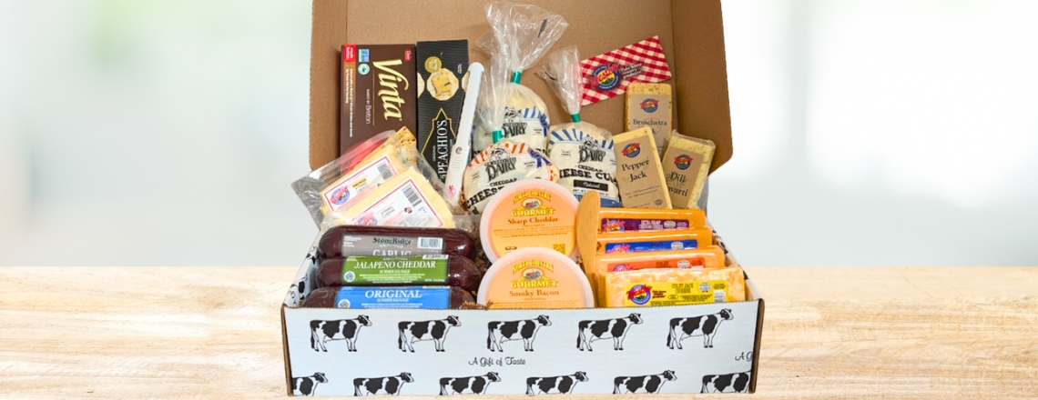 Westby Creamery Mega Cheese Box that includes over 13 lbs of meat and cheeses - including cheese curds, blocks of cheddar, and string cheese.